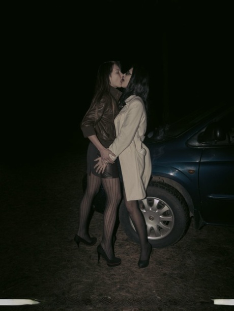 Lesbian lovers Helena J & Lexi B have sex inside of a car at night